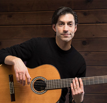 picture of Ken Jehle holding a guitar