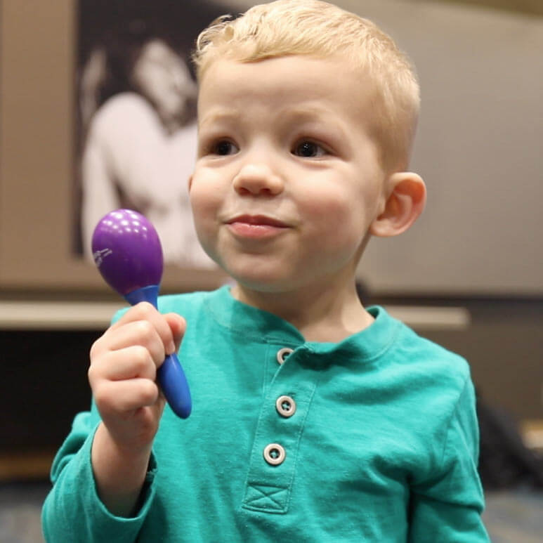 Photo: Holding a rattle.